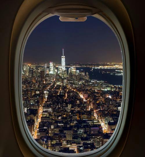 View of a city at night from plane window