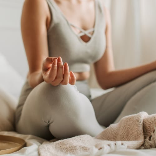Woman in yoga post with hands on her knees