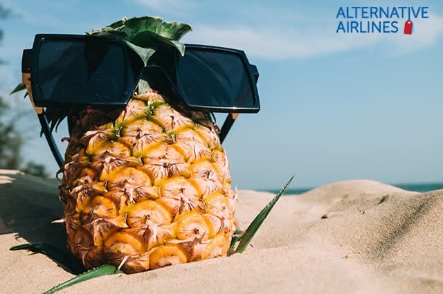 pineapple with sunglasses on a beach