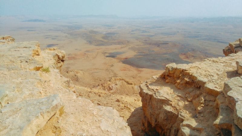 A view of the yellow rock of Ramon Crater in the Negev Desert, Israel. No plants or greenery can be seen for miles