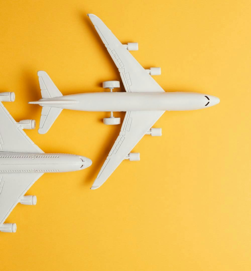 Two model aircraft against a yellow background