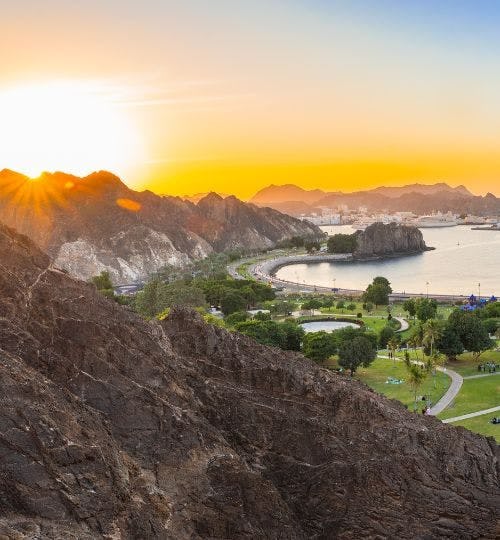 View of Muscat waterfront, Oman, at sunset