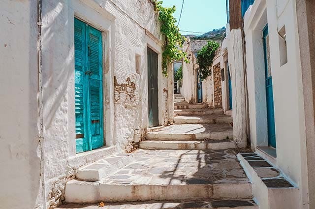 An old white and blue cobbled street in old town Naxos