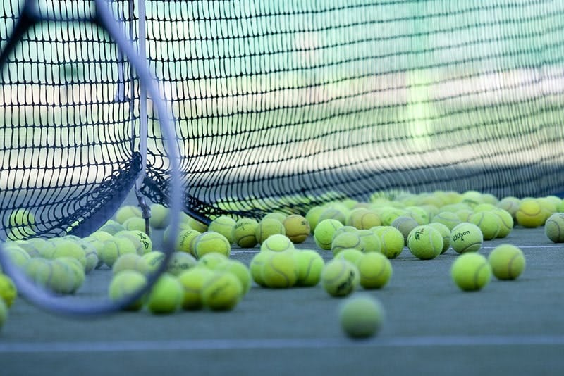 Tennis balls loose on a court