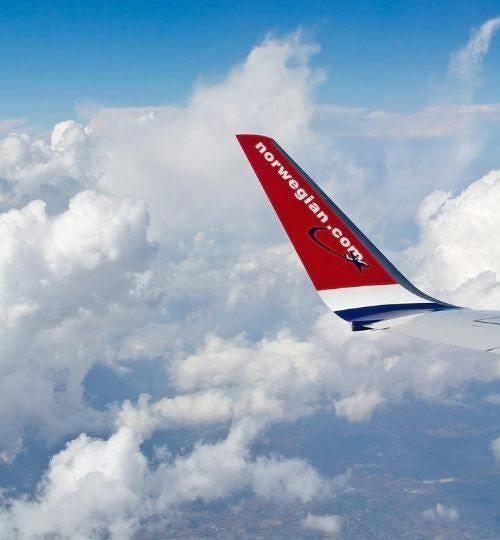 The wing of a Norwegian Airlines aircraft