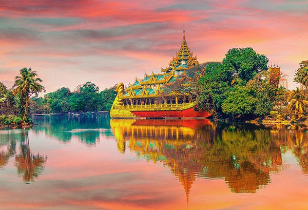 Picture of a boat on a river by a Thai temple